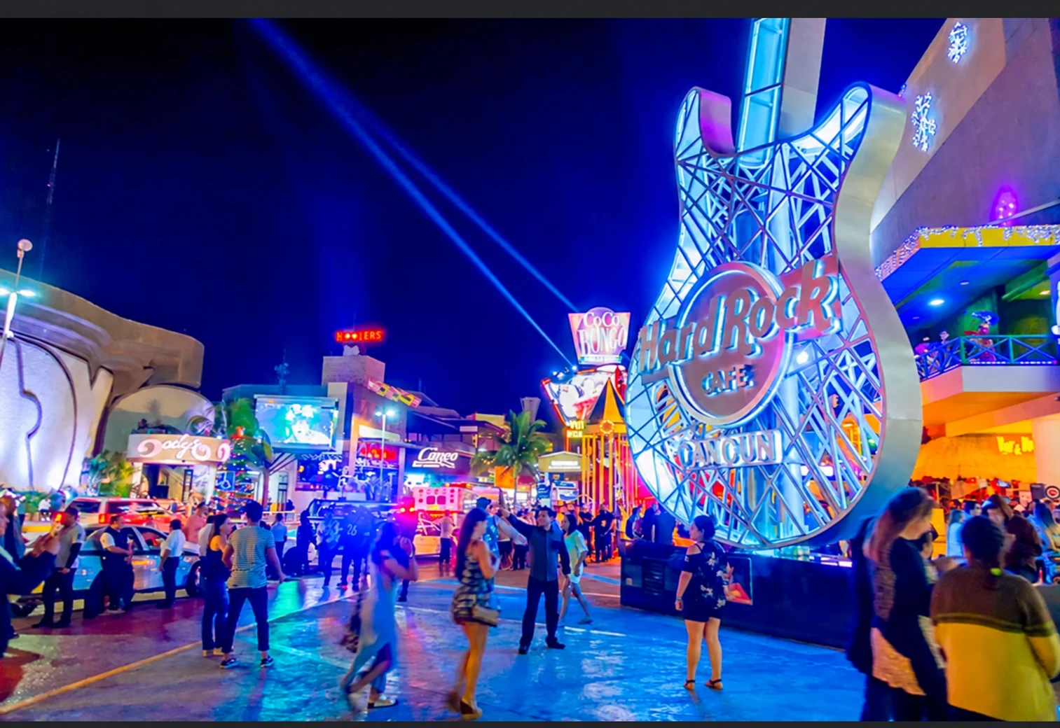 Cancún nightlife street with illuminated venue signs