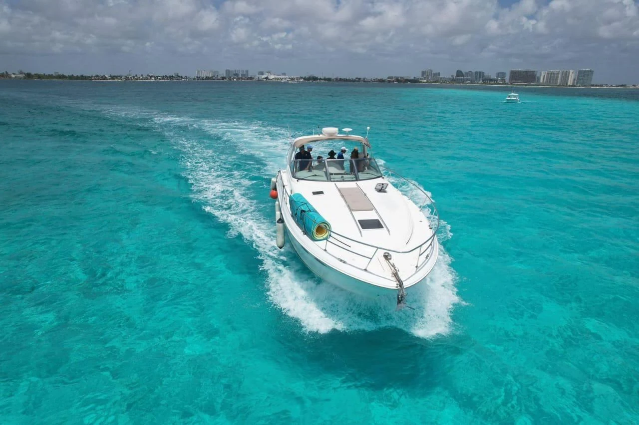 White motor yacht cruising through turquoise water